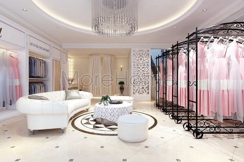 . Không gian showroom áo cưới Calla Lily cao cấp được thiết kế với sự có mặt của bộ sofa da màu trắng và thanh treo quần áo màu đen tạo nên điểm nhấn nổi bật cho căn phòng.